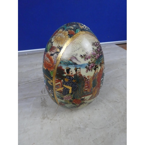 404 - An oriental patterned ceramic egg ornament.