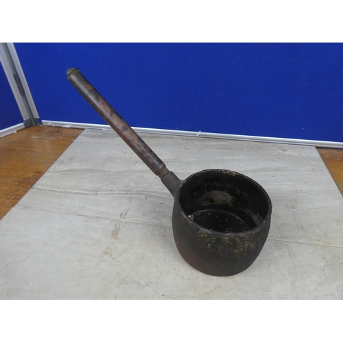 426 - A small antique saucepan with a copper handle.