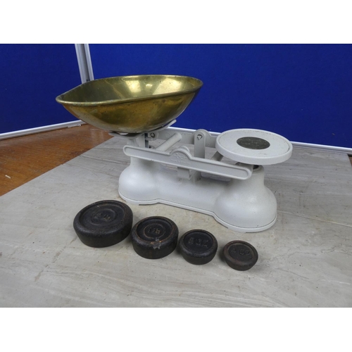 427 - A set of cream cast iron kitchen scales and brass weights.