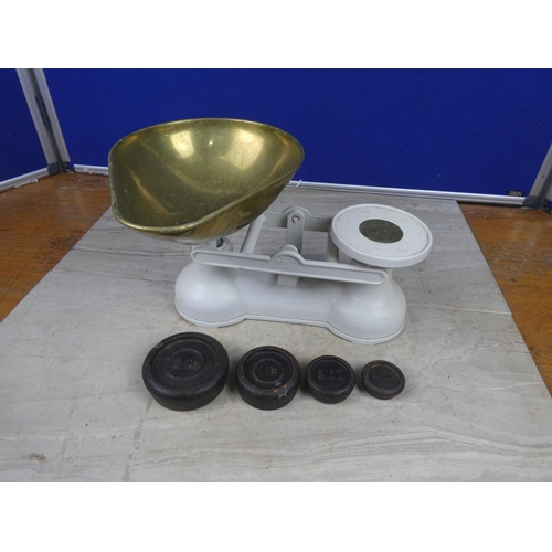 427 - A set of cream cast iron kitchen scales and brass weights.