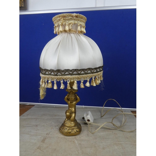 469 - A cherub based table lamp and shade.  Approx 43cm.