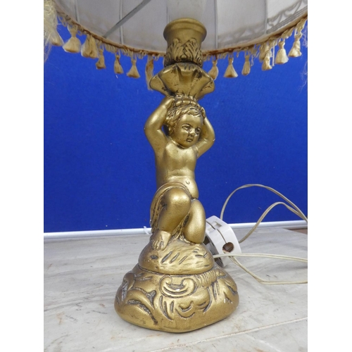 469 - A cherub based table lamp and shade.  Approx 43cm.