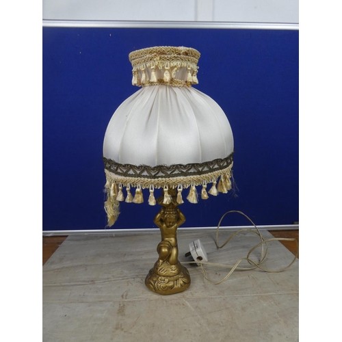 469 - A cherub based table lamp and shade.  Approx 43cm.