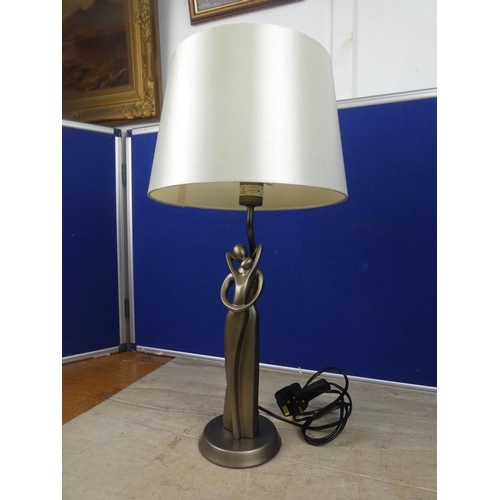 473 - A modern figurine based table lamp and shade.  Approx 55cm.