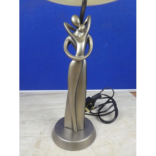 473 - A modern figurine based table lamp and shade.  Approx 55cm.