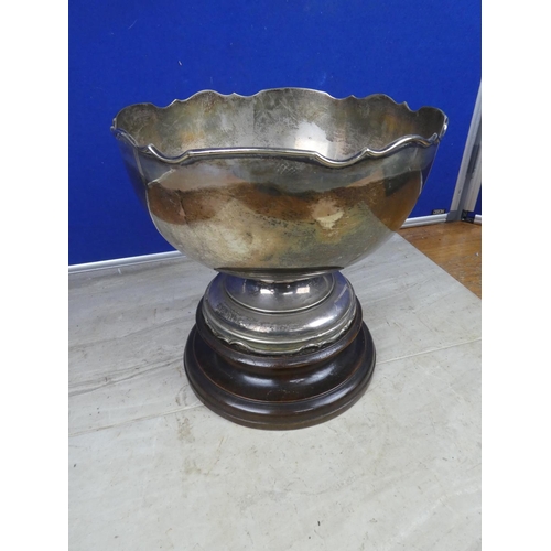 477 - A very large EPNS presentation bowl on wooden base.  Approx 25cm.