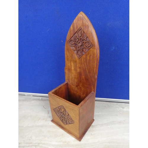 488 - A wooden candle box with carved detail.