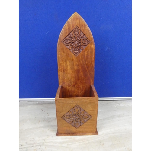 488 - A wooden candle box with carved detail.