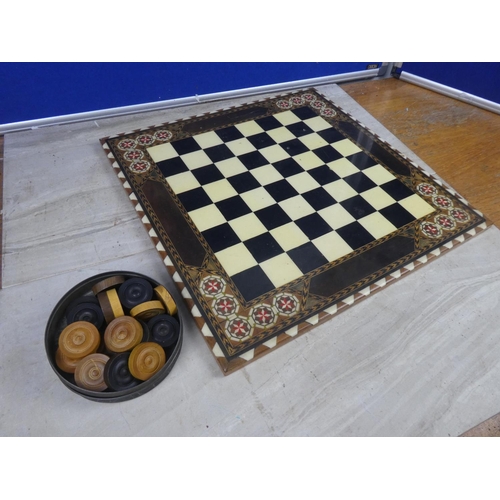 494 - A decorative resin draught board and counters.