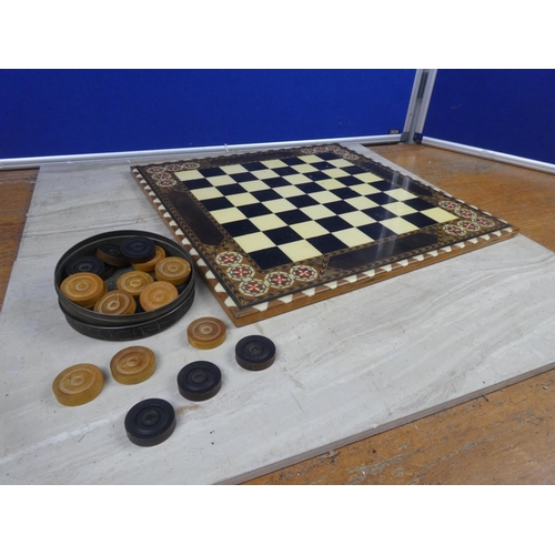 494 - A decorative resin draught board and counters.