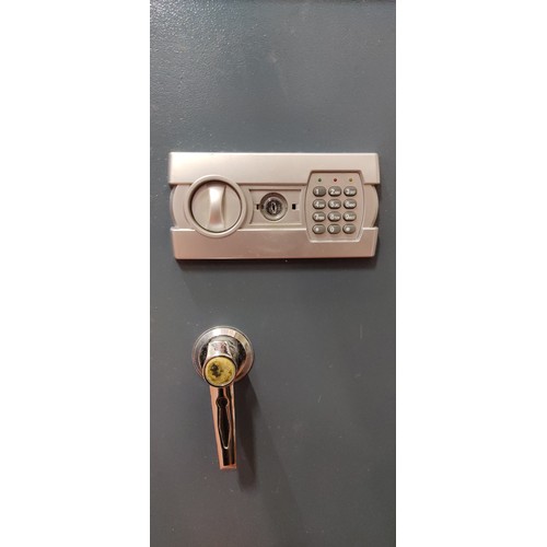 65 - A large safe with key.  Approx 52x89x48cm.