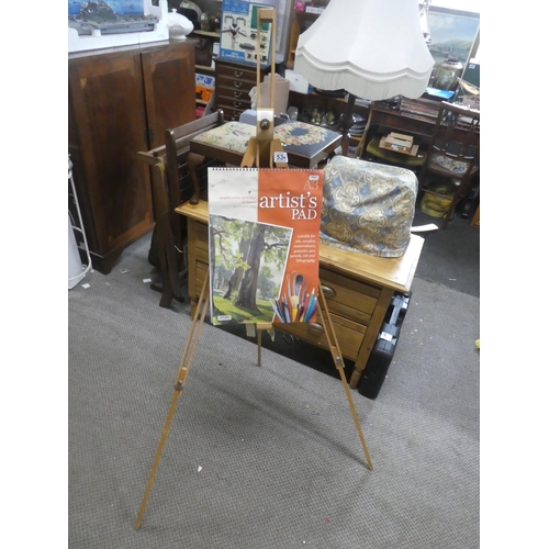 534 - An artist's easel and sketch pad.