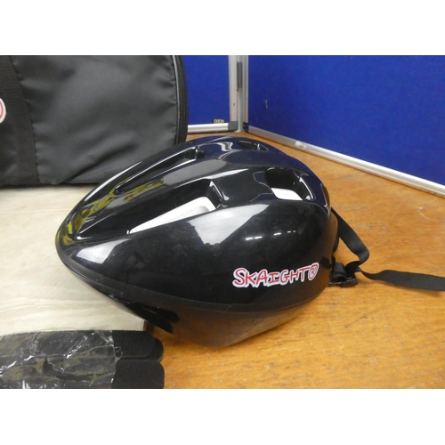 540 - A Skaight skateboard, helmet and bag.