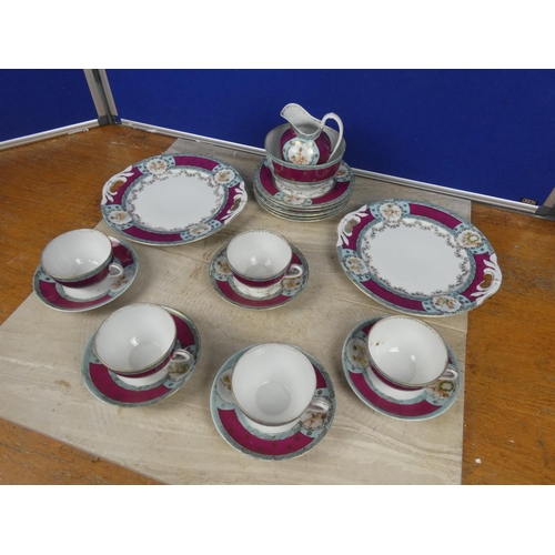 548 - A vintage bone china tea set decorated with cherub figures.