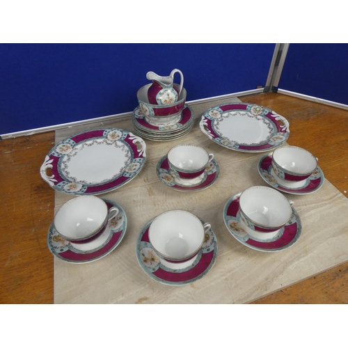 548 - A vintage bone china tea set decorated with cherub figures.