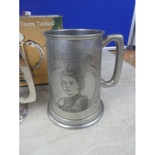 556 - An English pewter tankard 'The Silver Jubilee' and another boxed 'The Tavern Tankard'.