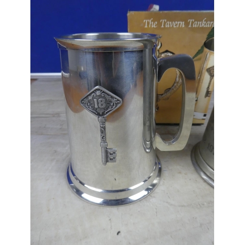 556 - An English pewter tankard 'The Silver Jubilee' and another boxed 'The Tavern Tankard'.