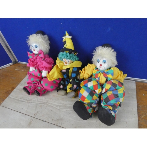 561 - Three toy clowns with ceramic faces.