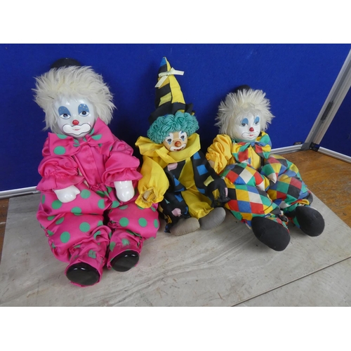 561 - Three toy clowns with ceramic faces.