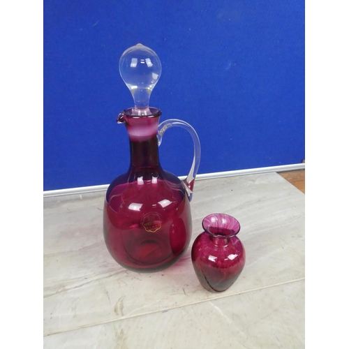 584 - A ruby glass decanter and vase.