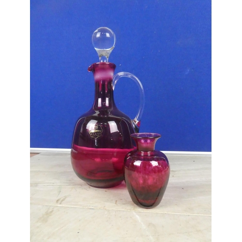 584 - A ruby glass decanter and vase.