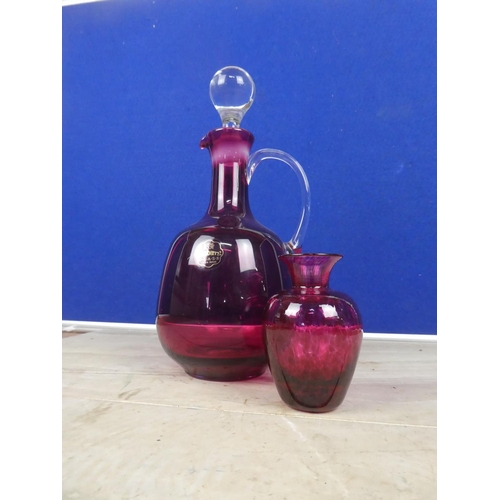 584 - A ruby glass decanter and vase.