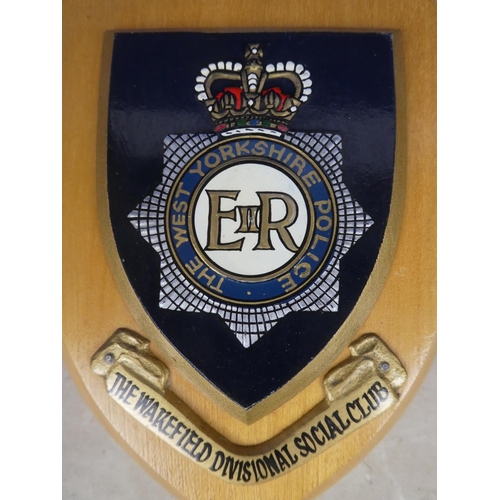 590 - A wooden wall plaque 'The West Yorkshire Police'.  Approx 15x19cm.