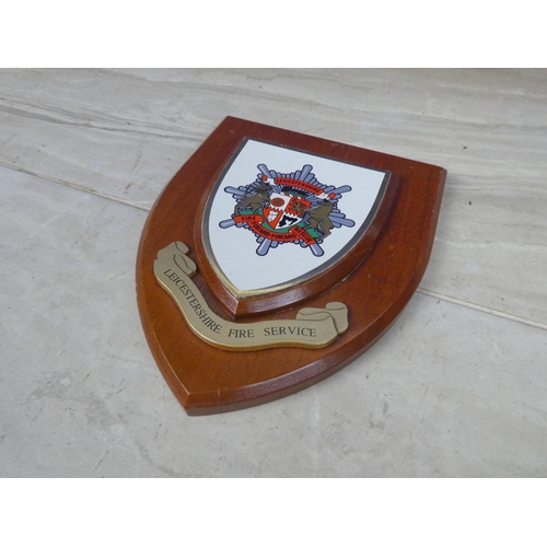 593 - A wooden wall plaque 'Leicestershire Fire Service'.  Approx 15x18cm.