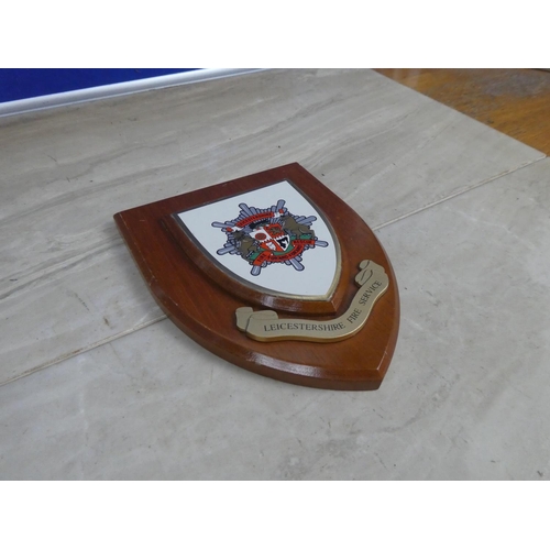 593 - A wooden wall plaque 'Leicestershire Fire Service'.  Approx 15x18cm.