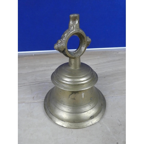 598 - An antique cast metal bell, inscribed 24.