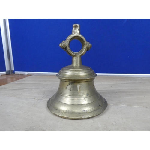 598 - An antique cast metal bell, inscribed 24.