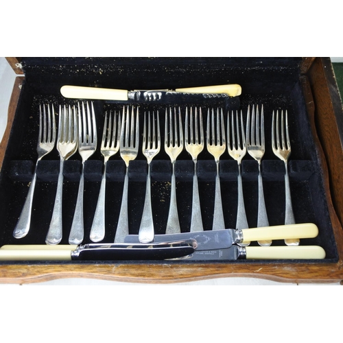 611 - A stunning antique oak cased canteen of cutlery by Joseph Rodgers & Sons and another.