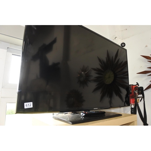 612 - A large Samsung flatscreen television and remote control.  46 inch.