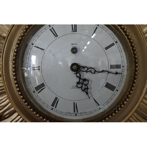 628 - A vintage Smiths 8 day wall clock with gilt case and key.  Approx 66x50cm.