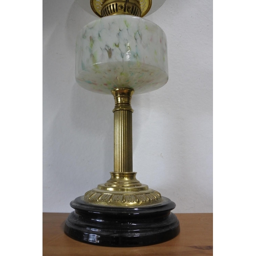 641 - A stunning antique oil lamp with multicoloured glass font and shade.  Approx 64cm.