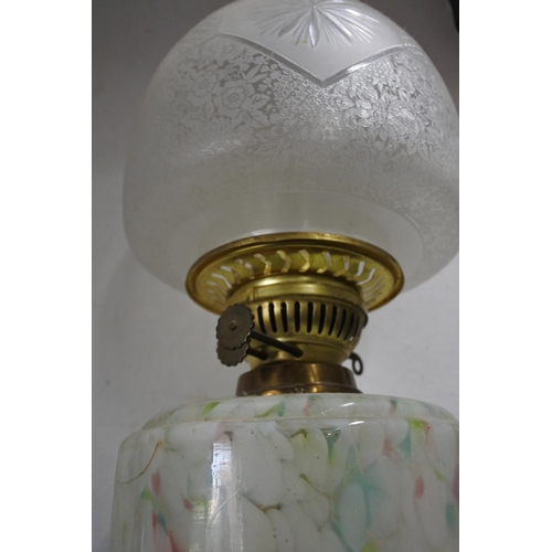 641 - A stunning antique oil lamp with multicoloured glass font and shade.  Approx 64cm.