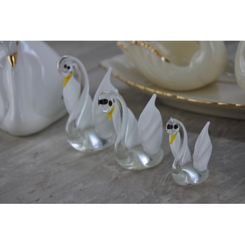 680 - A collection of swan ornaments and a dish.