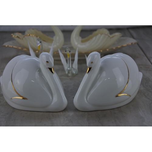 680 - A collection of swan ornaments and a dish.