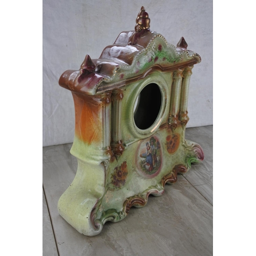 684 - An antique ceramic clock case.  Approx 36cm.