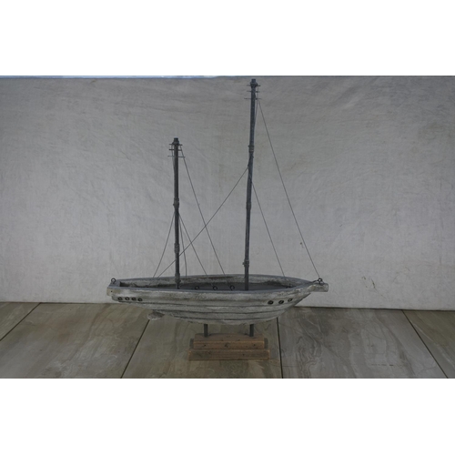 697 - A wooden ornamental boat on stand.