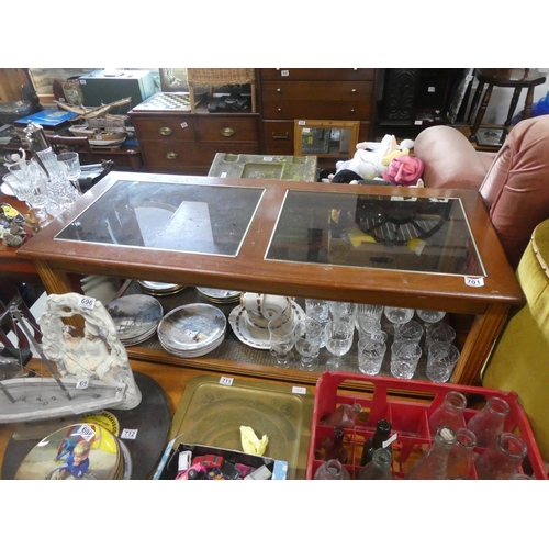 701 - A glass topped coffee table with rattan undershelf.