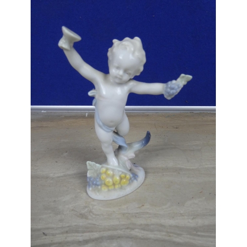 721 - A porcelain figure of a cherub or putti, European manufacturer, marks to the base and A Victorian Bo... 