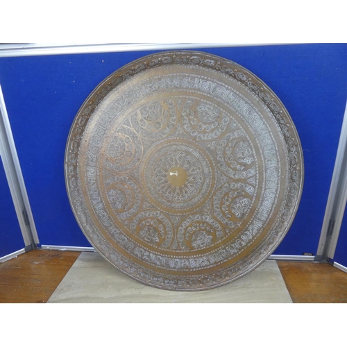 722 - A very large decorative brass charger.  Approx 59cm.