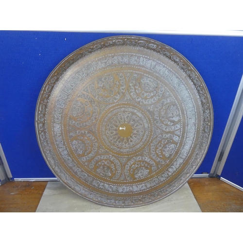 722 - A very large decorative brass charger.  Approx 59cm.