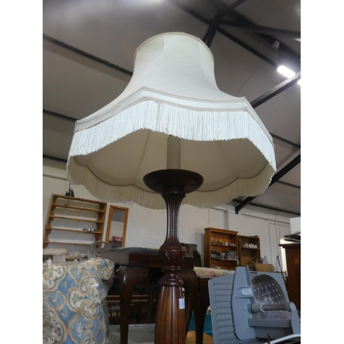 727 - A mahogany standard lamp and shade.  Approx 167cm.