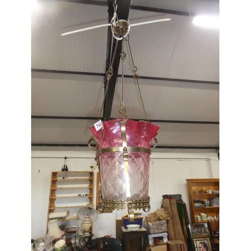 743 - A stunning antique ruby glass shade pendant light on  brass bracket.