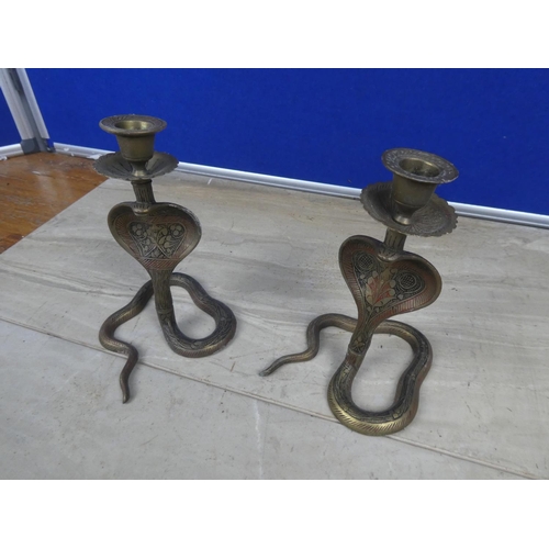 747 - A pair of brass candlesticks in the style of snake with decorative detail.  Approx 18cm.