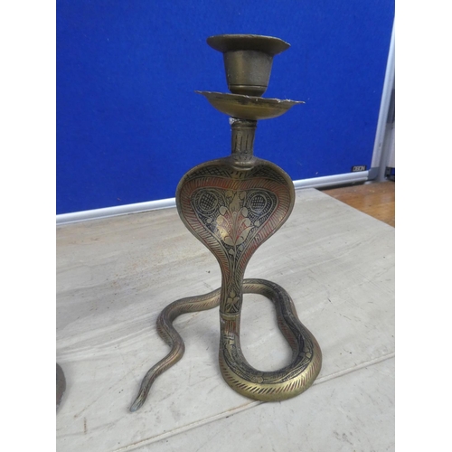 747 - A pair of brass candlesticks in the style of snake with decorative detail.  Approx 18cm.