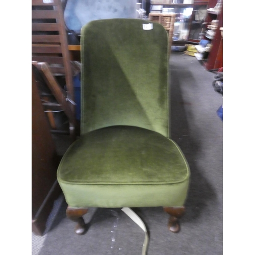 749 - A green velvet upholstered bedroom chair.