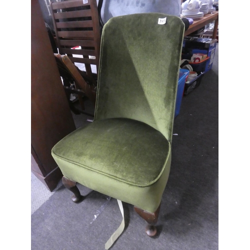 749 - A green velvet upholstered bedroom chair.